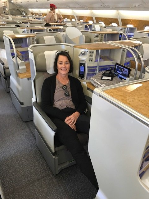 Woman sitting in business class on Emirates airplane