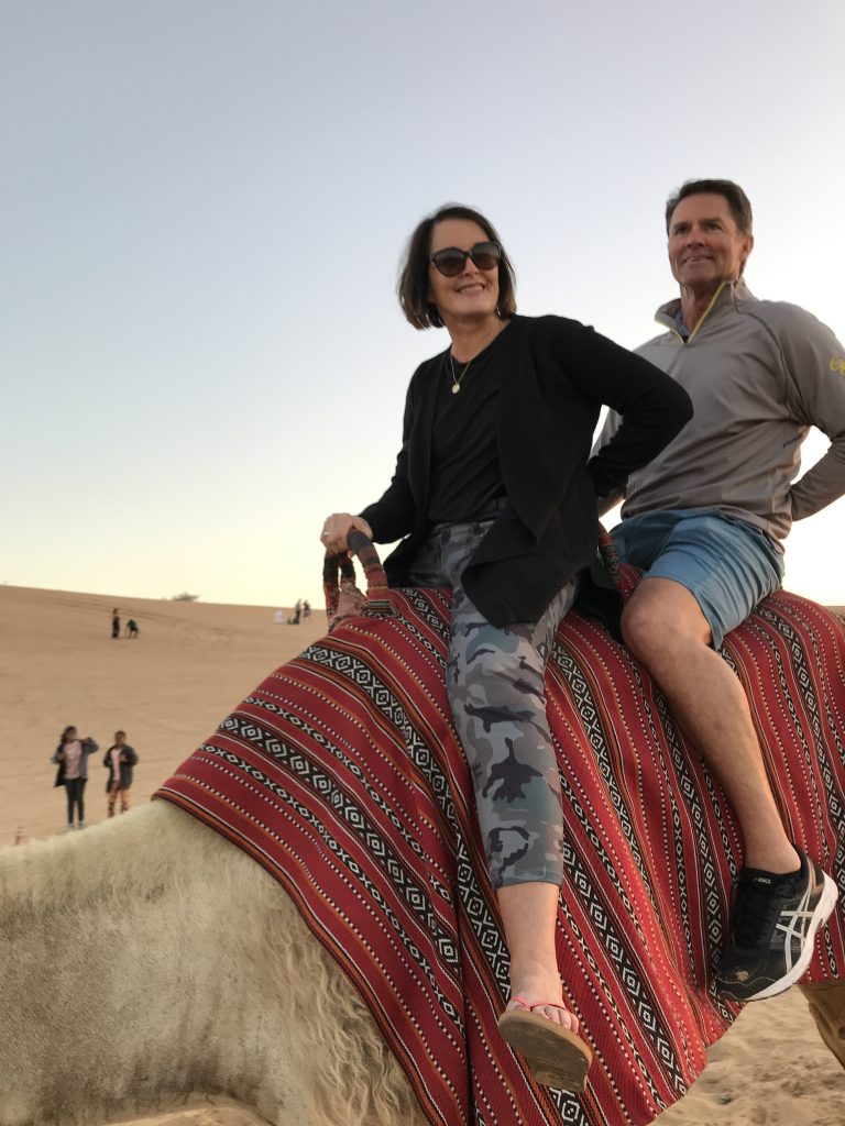 A woman and man on a camel