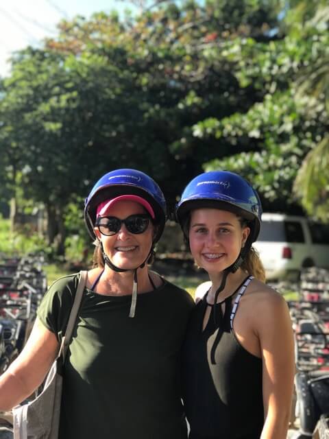Older woman and granddaughter with ATV helmets on