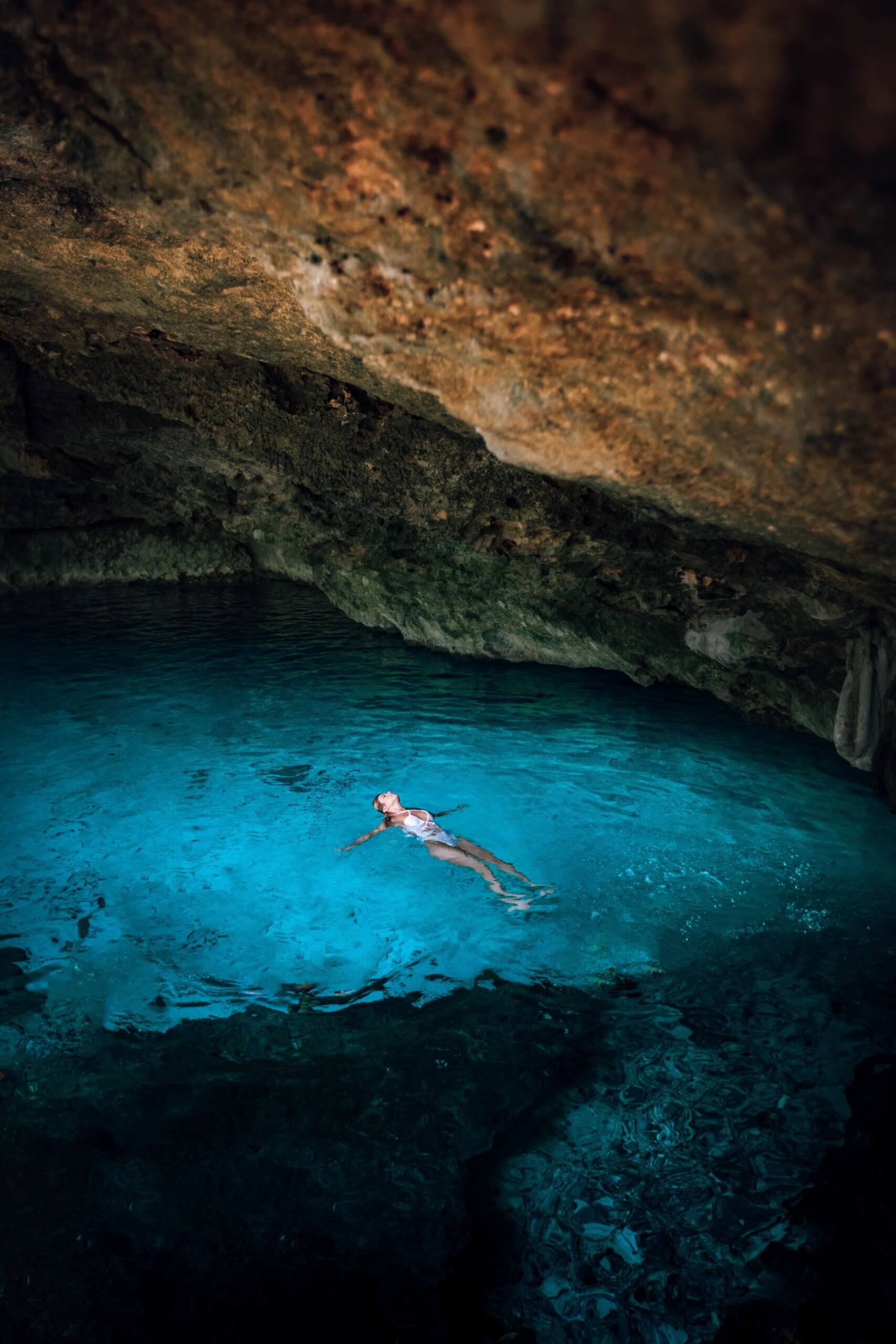 Woman swimming in cave