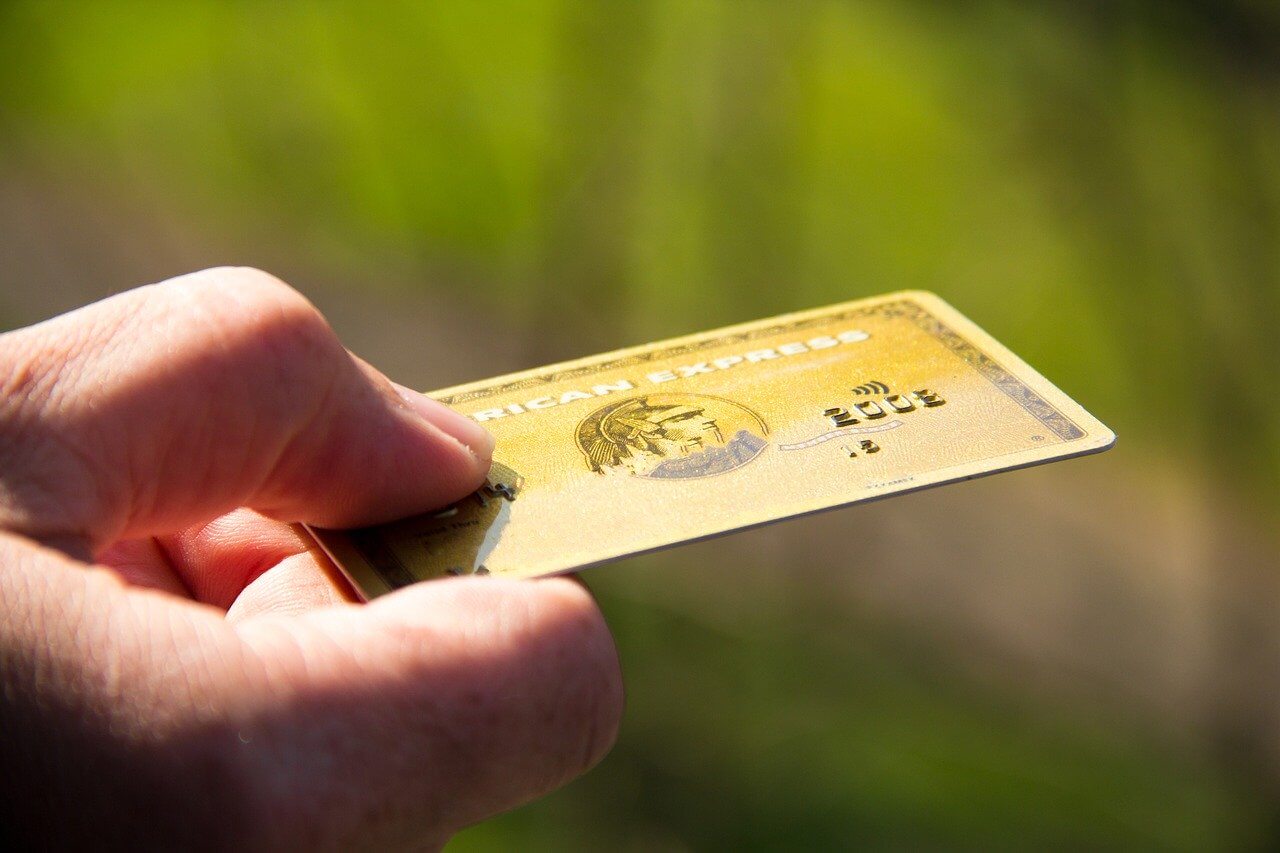 Person holding gold credit card