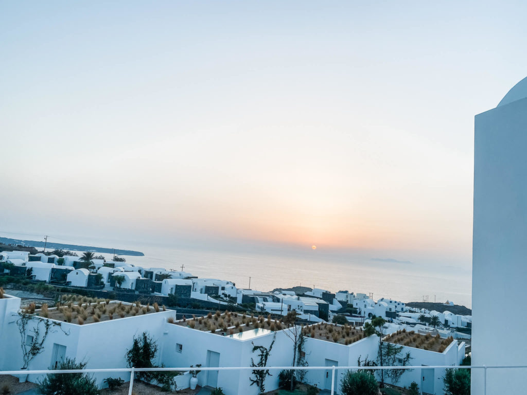 Sunset over ocean with white buildings