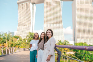 Three women in front of towers