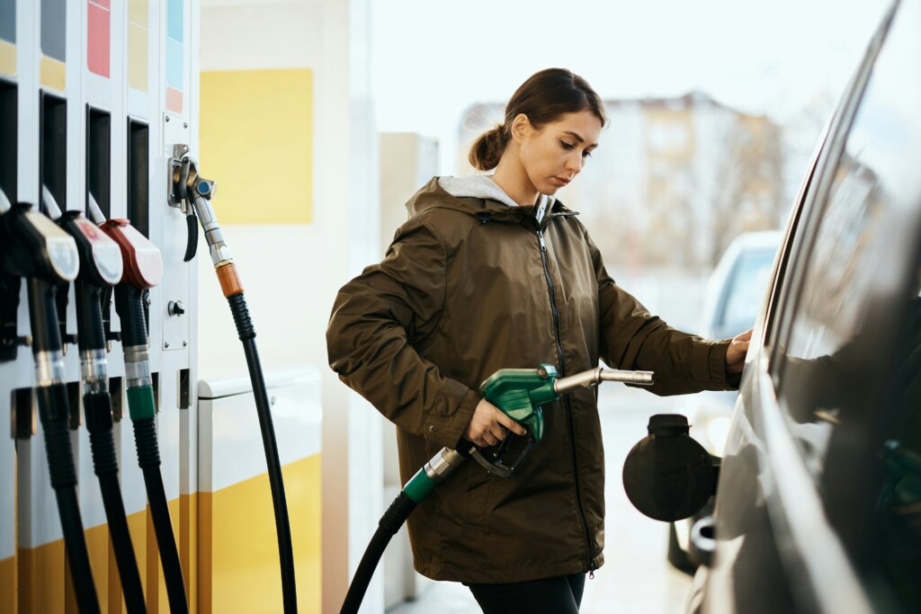 Woman putting gas in her car