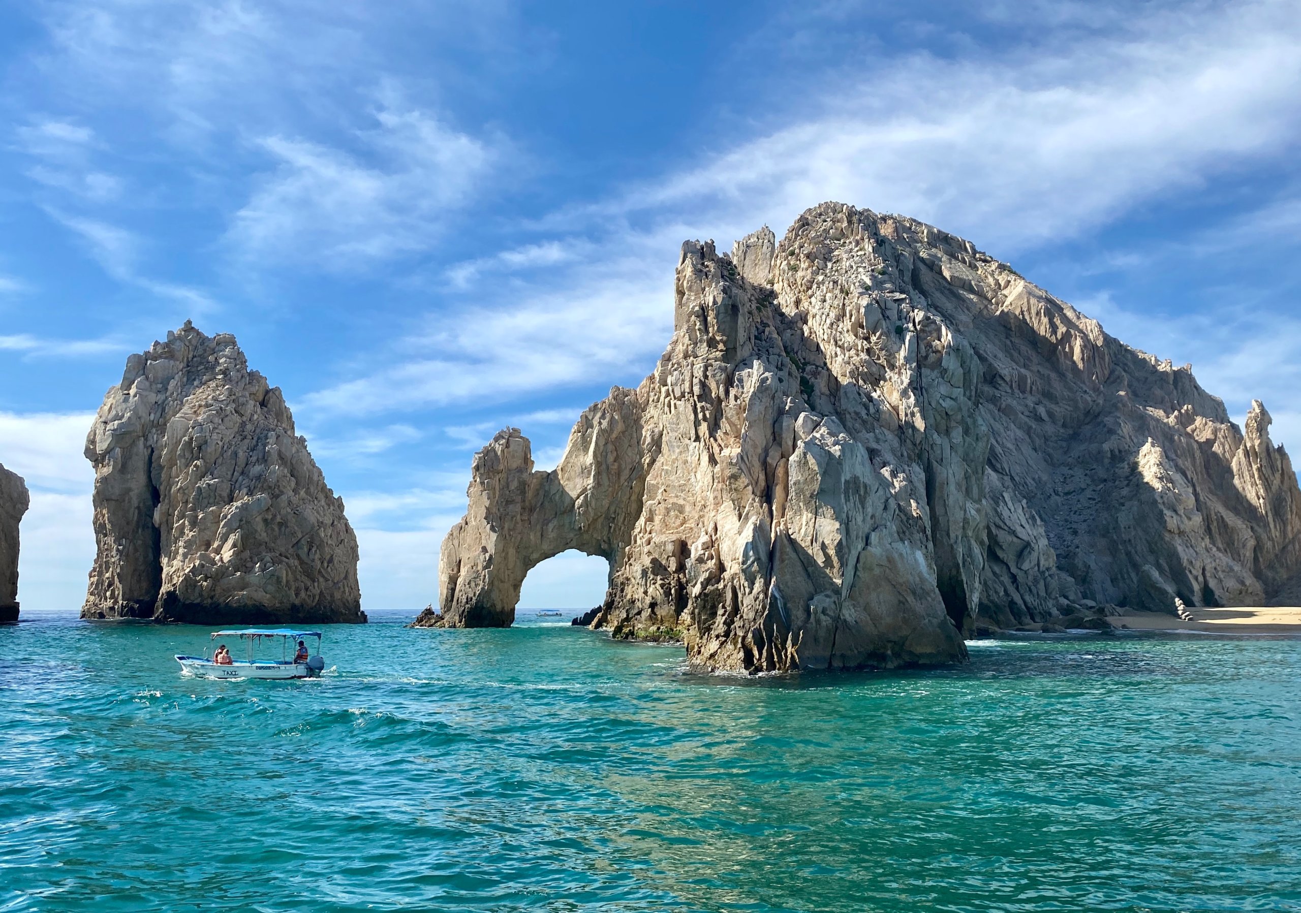Arched rock formation in blue water