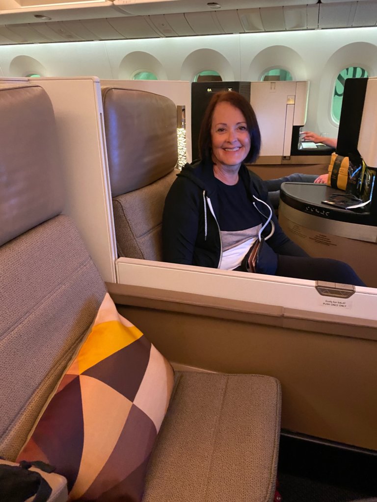 Woman sitting in brown seats on airline