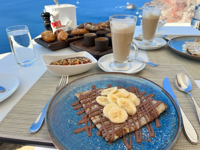 Breakfast items on table overlooking blue water