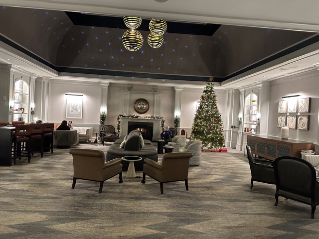 Grey hotel lobby with fireplace and Christmas tree