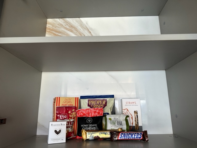 Several snacks in cupboard.