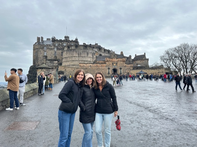 3 woman outside a castle