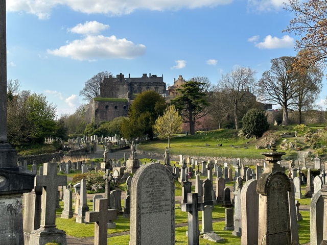 Cemetery in foreground with castle on a hill