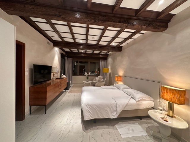 Hotel bedroom with wood beams.