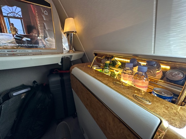 Cabin of airplane with beverages on the side.