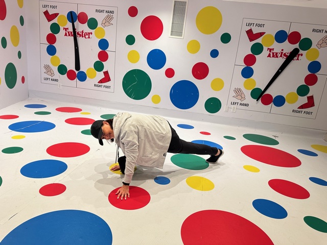 Woman playing game of life-size Twister.
