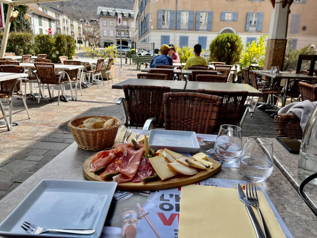 Meat on cheese on plate in outdoor cafe