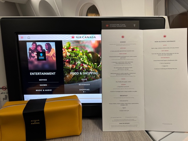 Menu and amenity kit in front of screen.