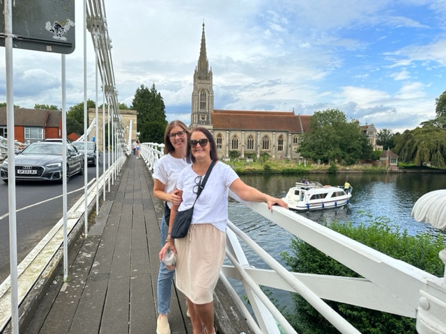 Two women standing on bridge