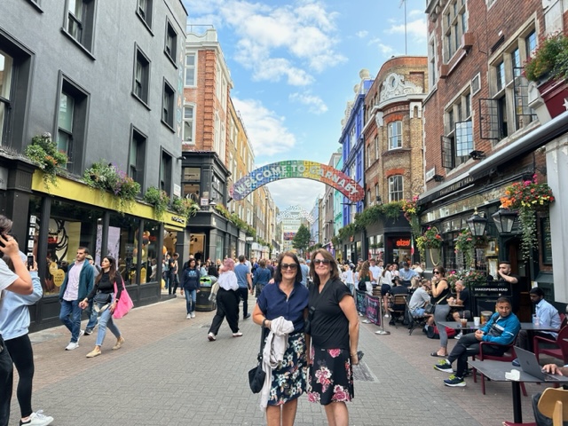 two women under sign that says Carnaby Street