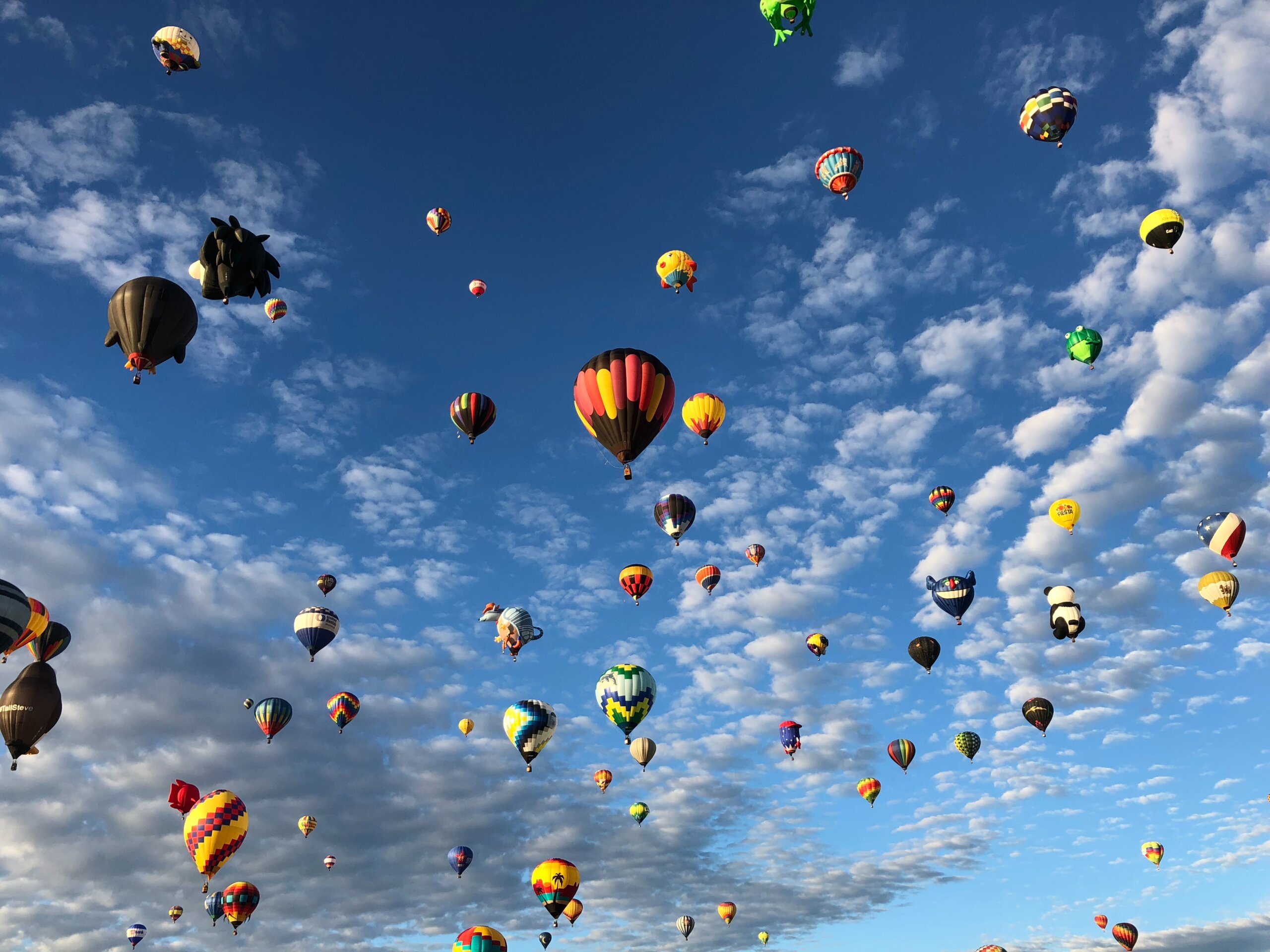 Large bright colored balloons in blue sky