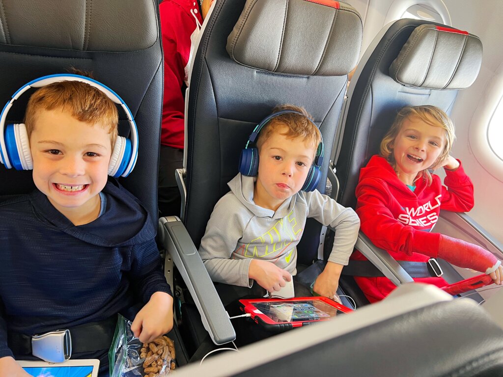 Three children sitting on plane.