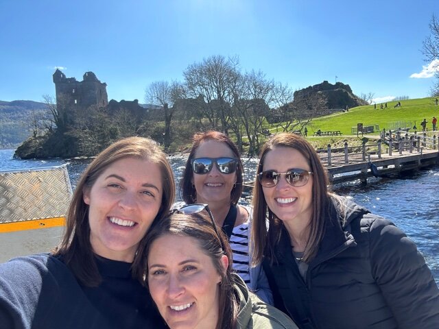 Four women in front of castle.