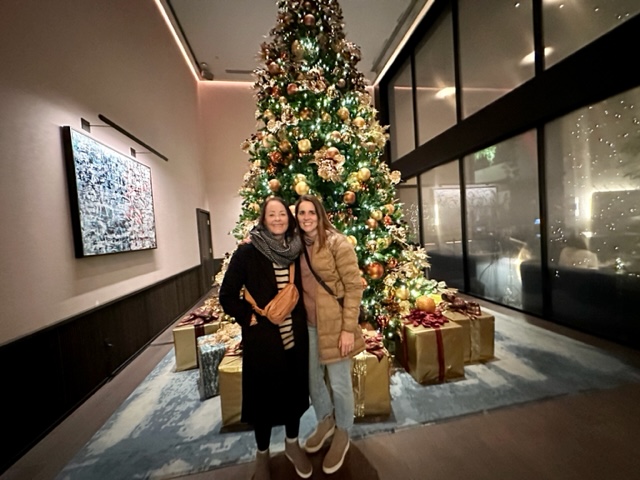 Two women in front of Christmas Tree