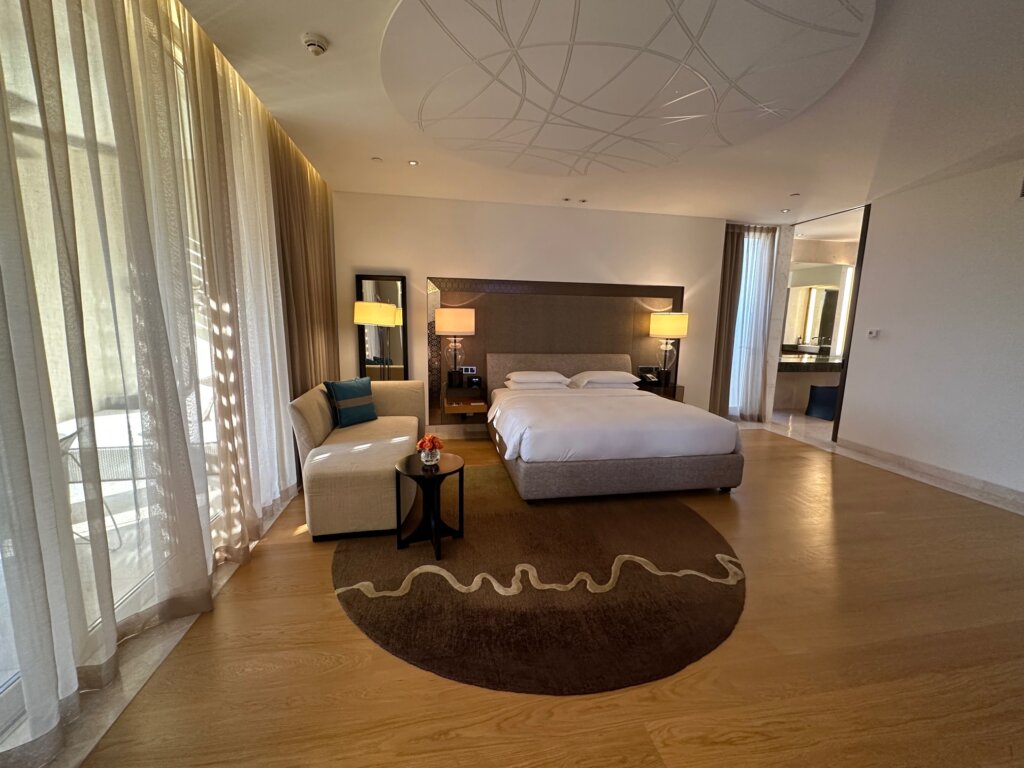 Large hotel room with white bed