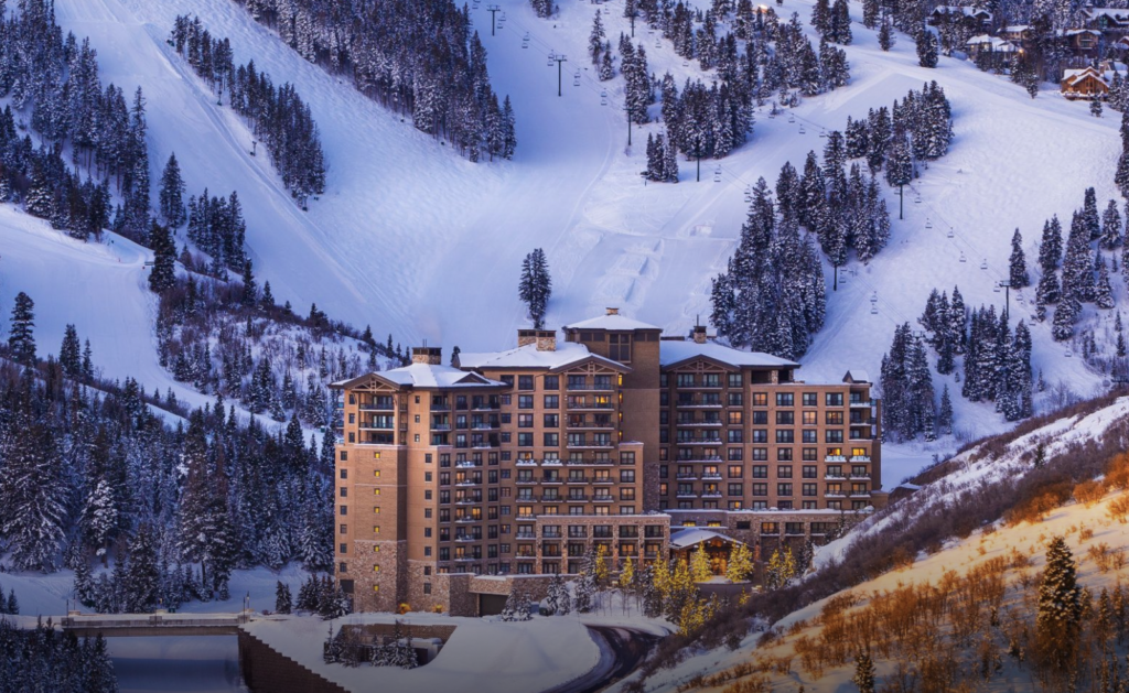 Large hotel located between snow slopes.