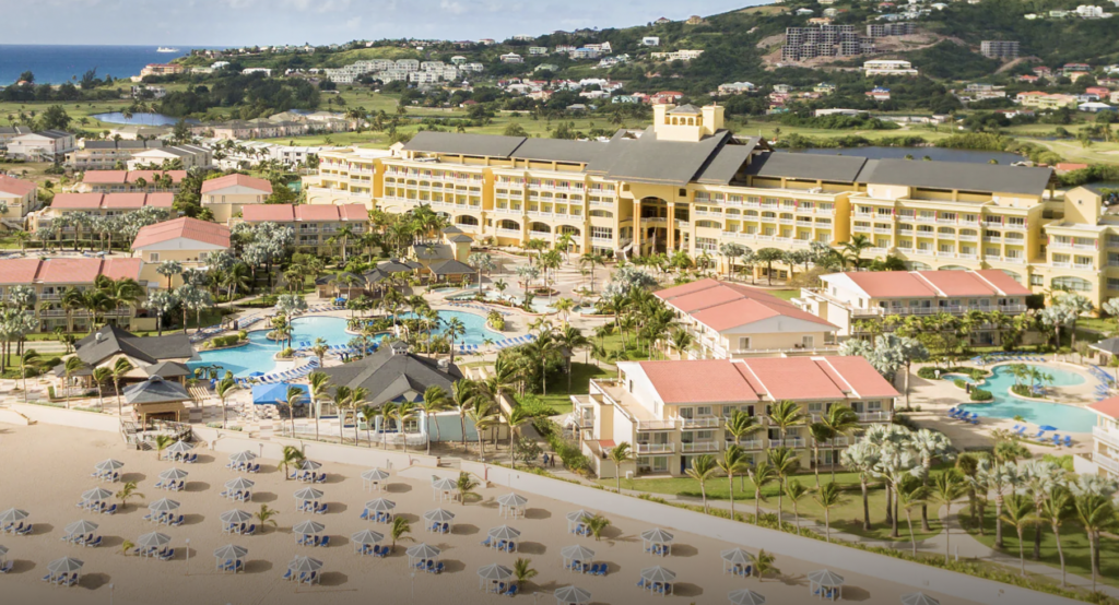 Aerial view of resort on a beach.