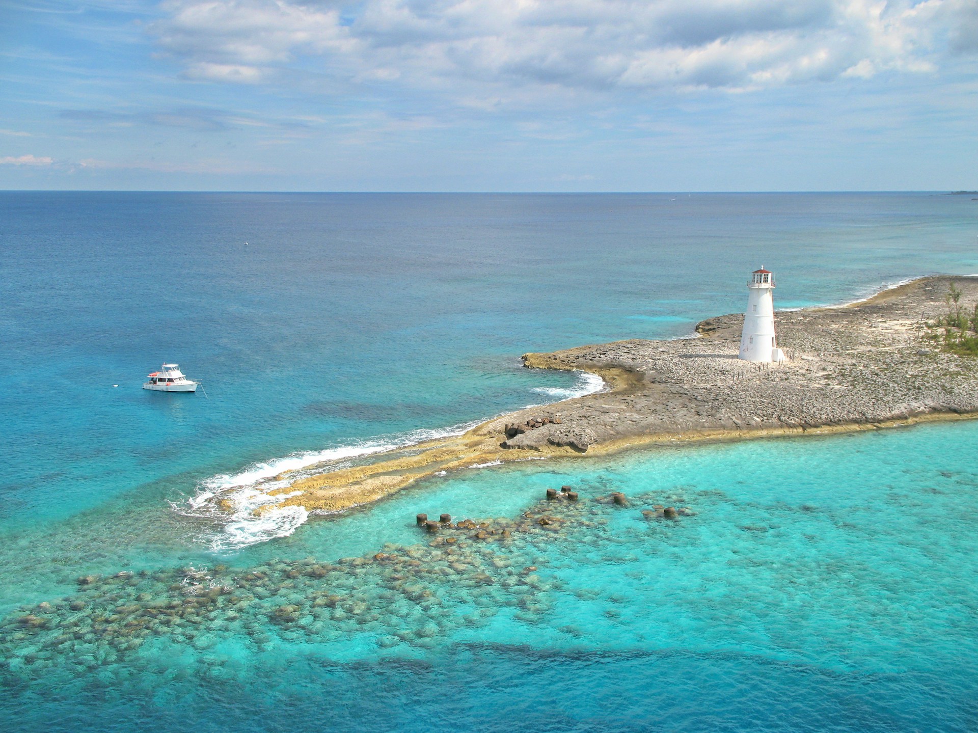 Island in turquoise water and lighthouse on island