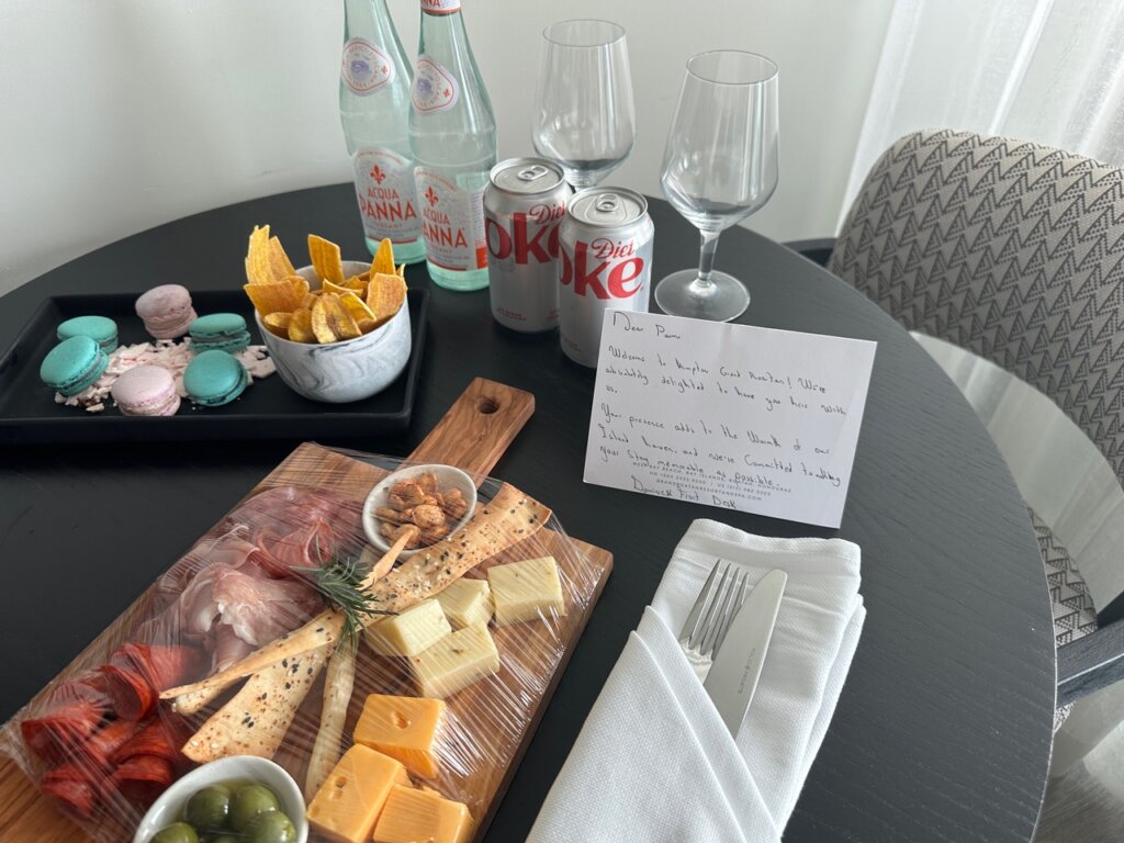 Hotel room with treats and welcome note.