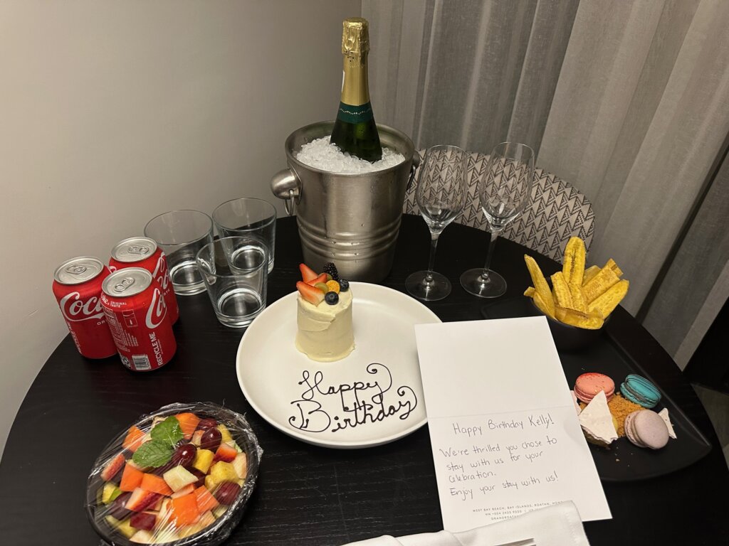 Beverages and treats with a note on a table.
