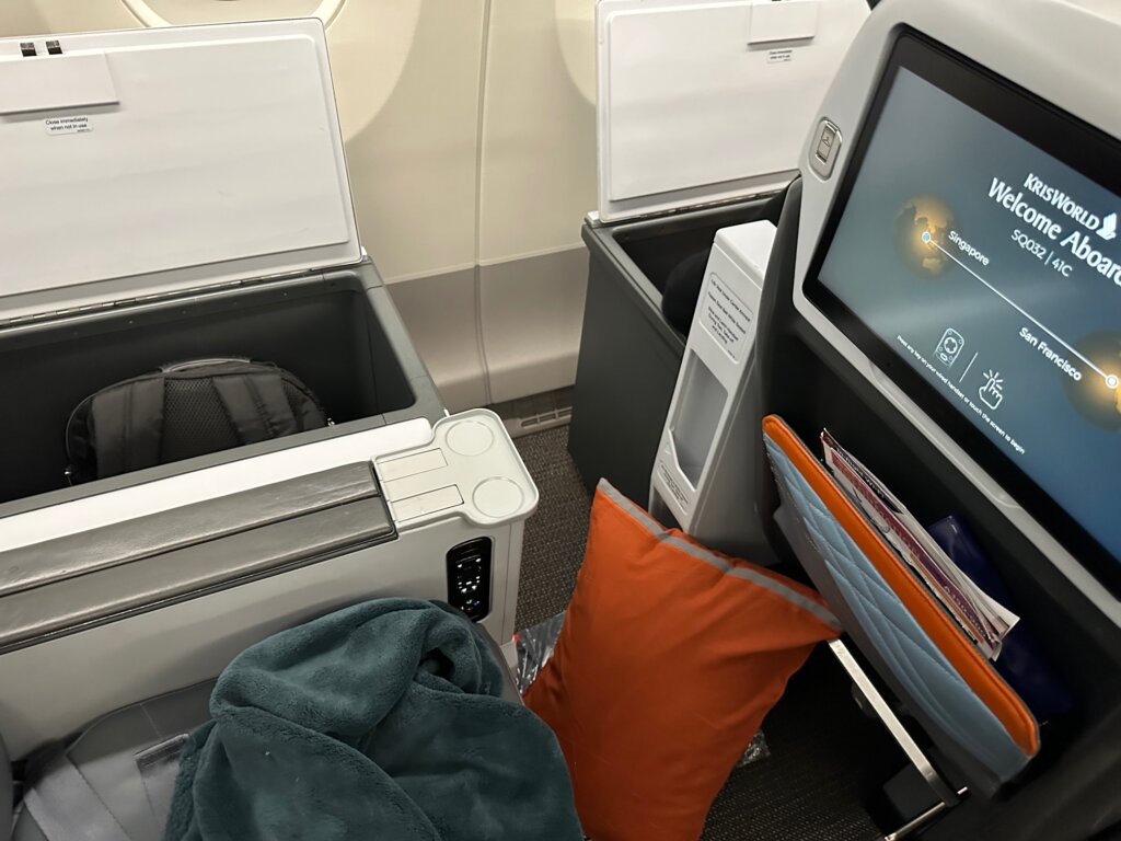 Airline seat on airline with large cabinet