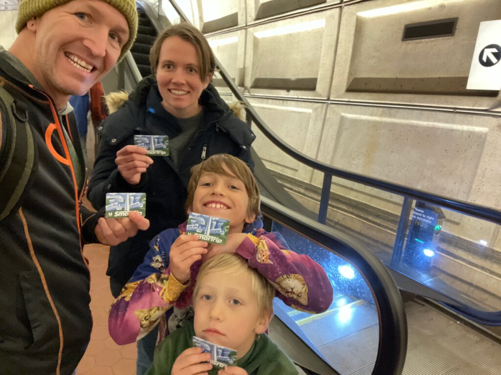 2 boys and man and woman near escalator