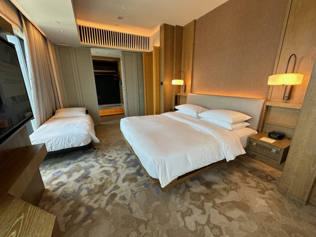 Bedroom in hotel with king bed and rollaway