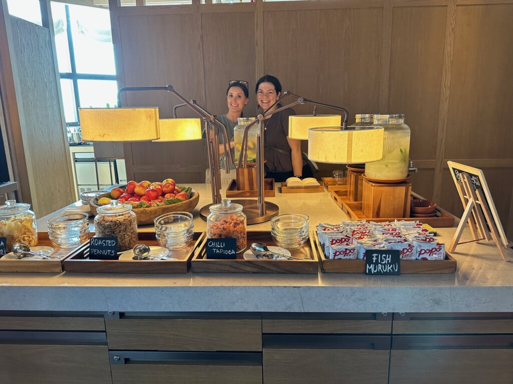 Two women by snack table in a hotel