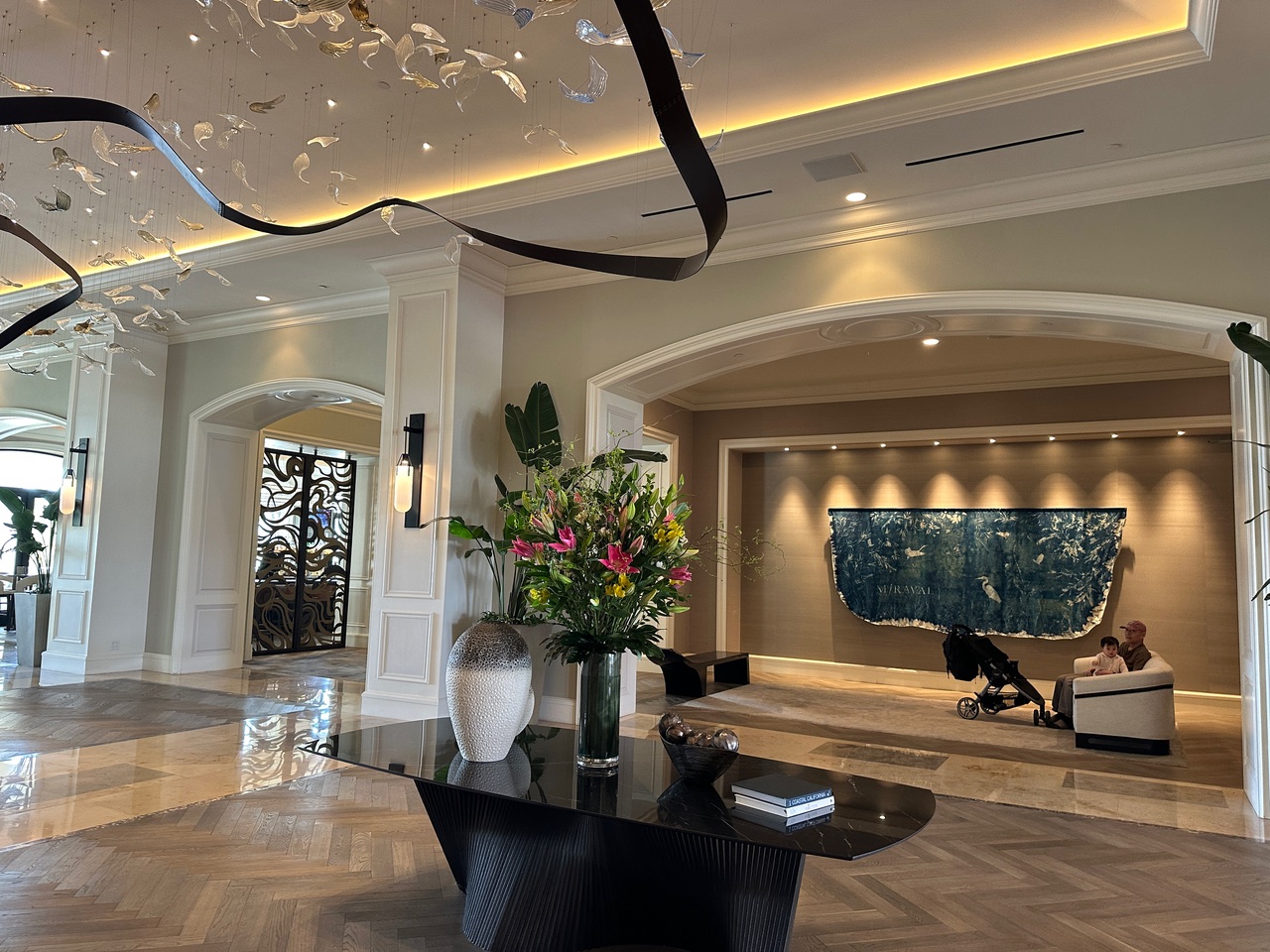 Hotel lobby with marble and large flower arrangement