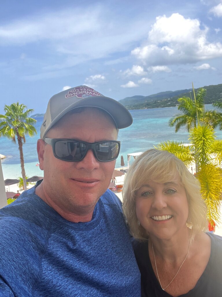 Man and women with beach in background