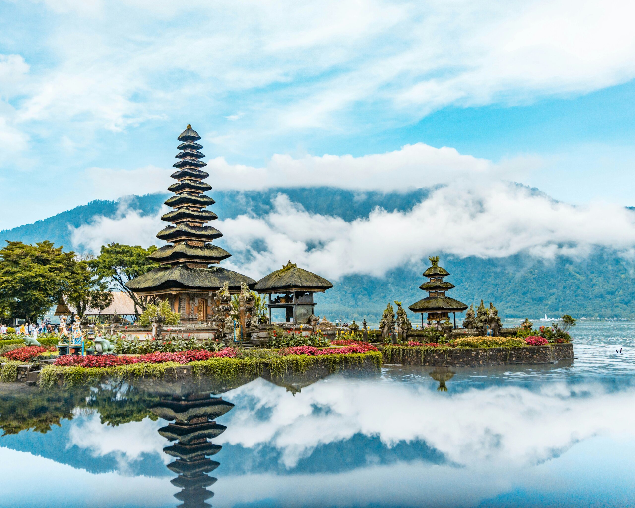 Asian temple near water with clouds surrounding