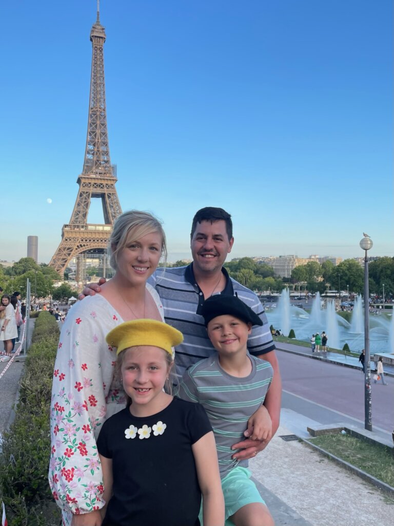 family of four in front of a tower