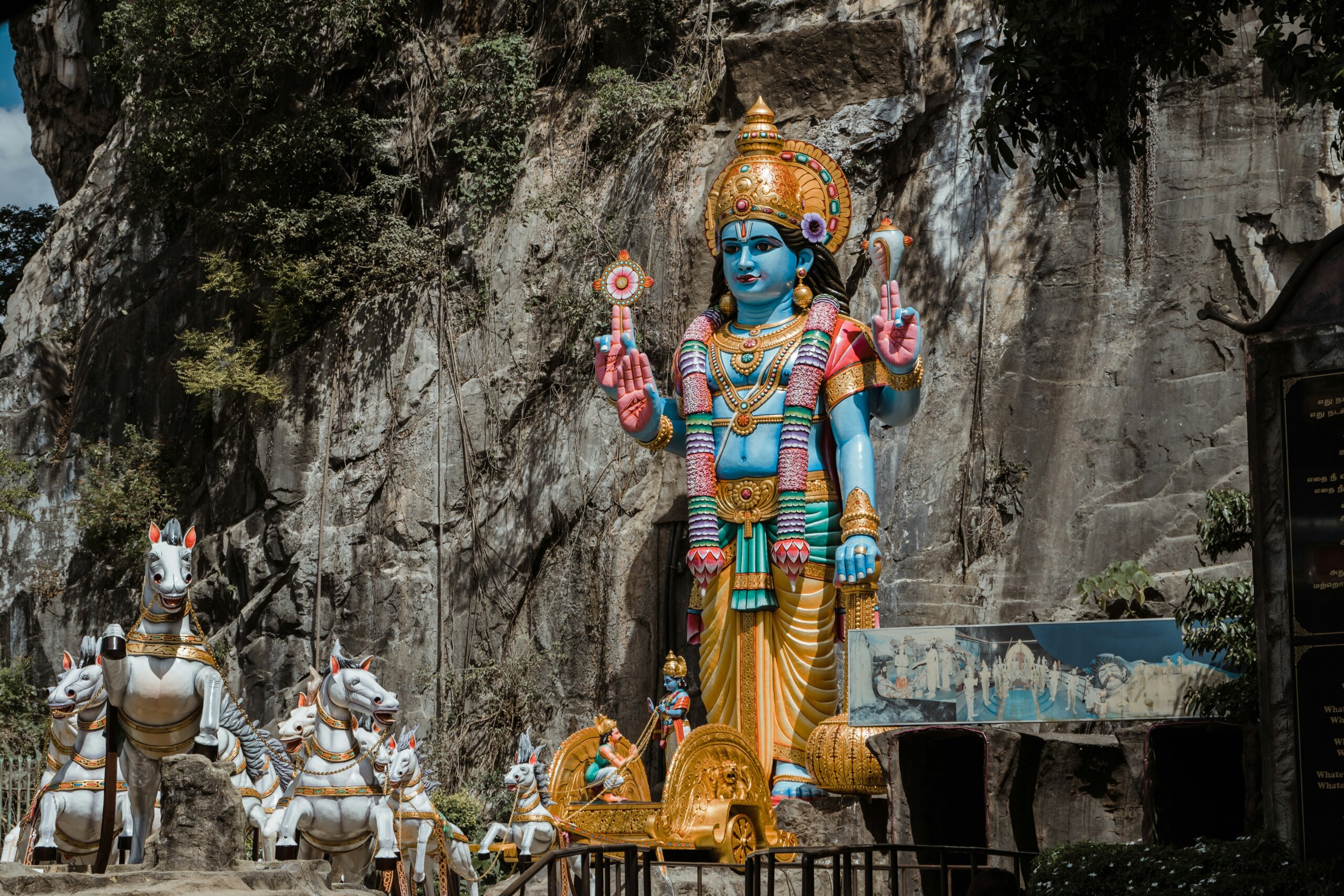 Colorful gold statue near grey mountain