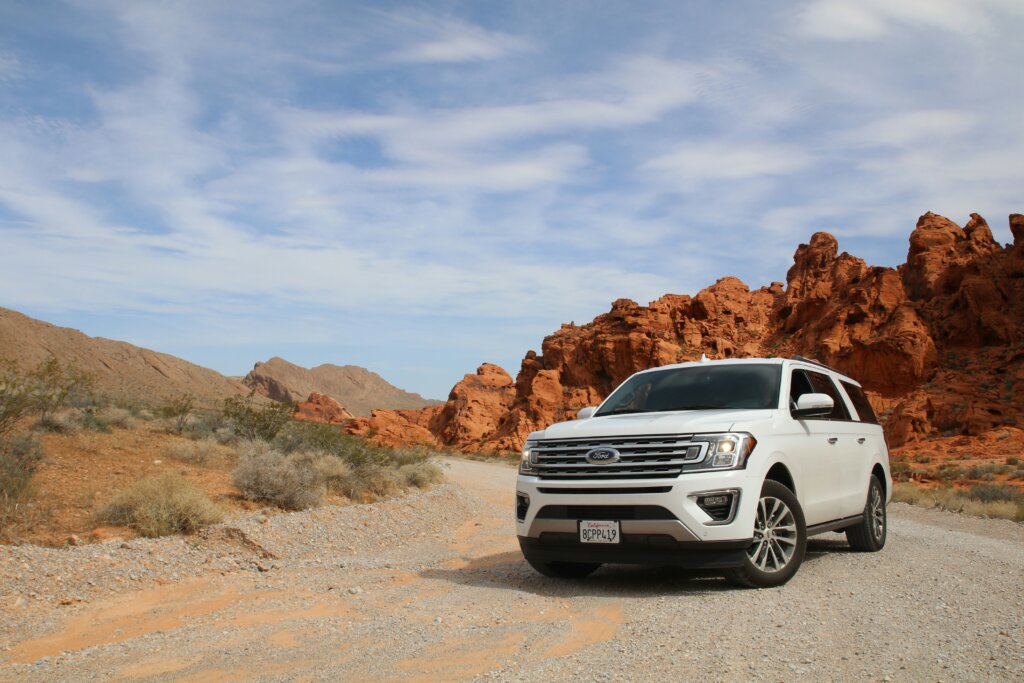 White vehicle on dirt road