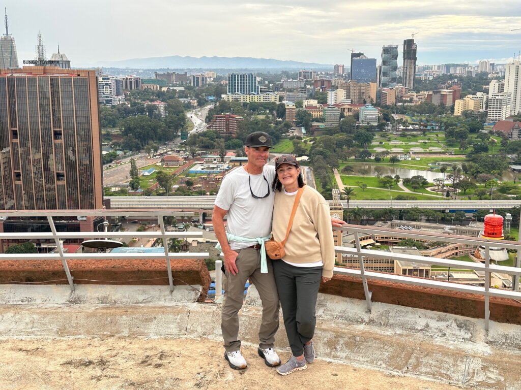 Man and woman on building overlooking large city