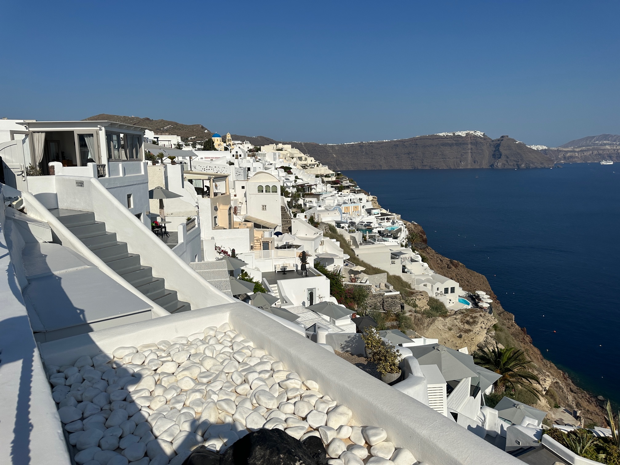 View of city with White stucco buildings and blue water