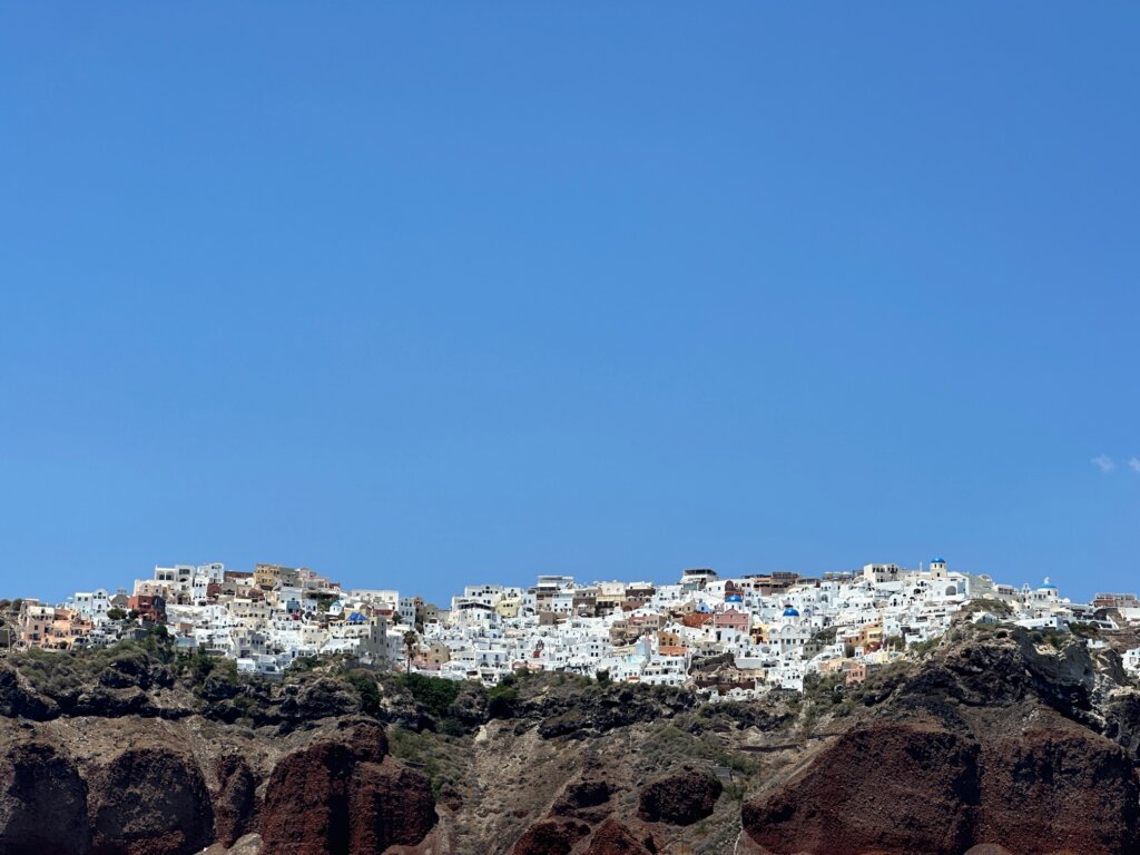 Water's view of city of white stucco buildings