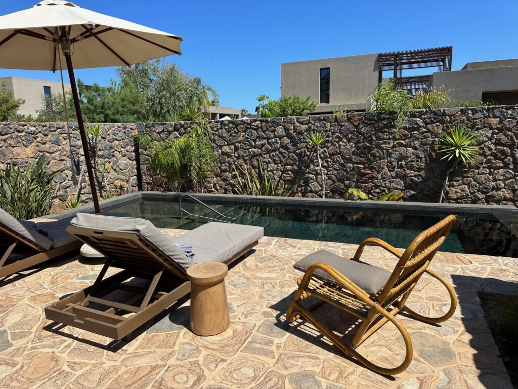 Outdoor pool with umbrella and chairs