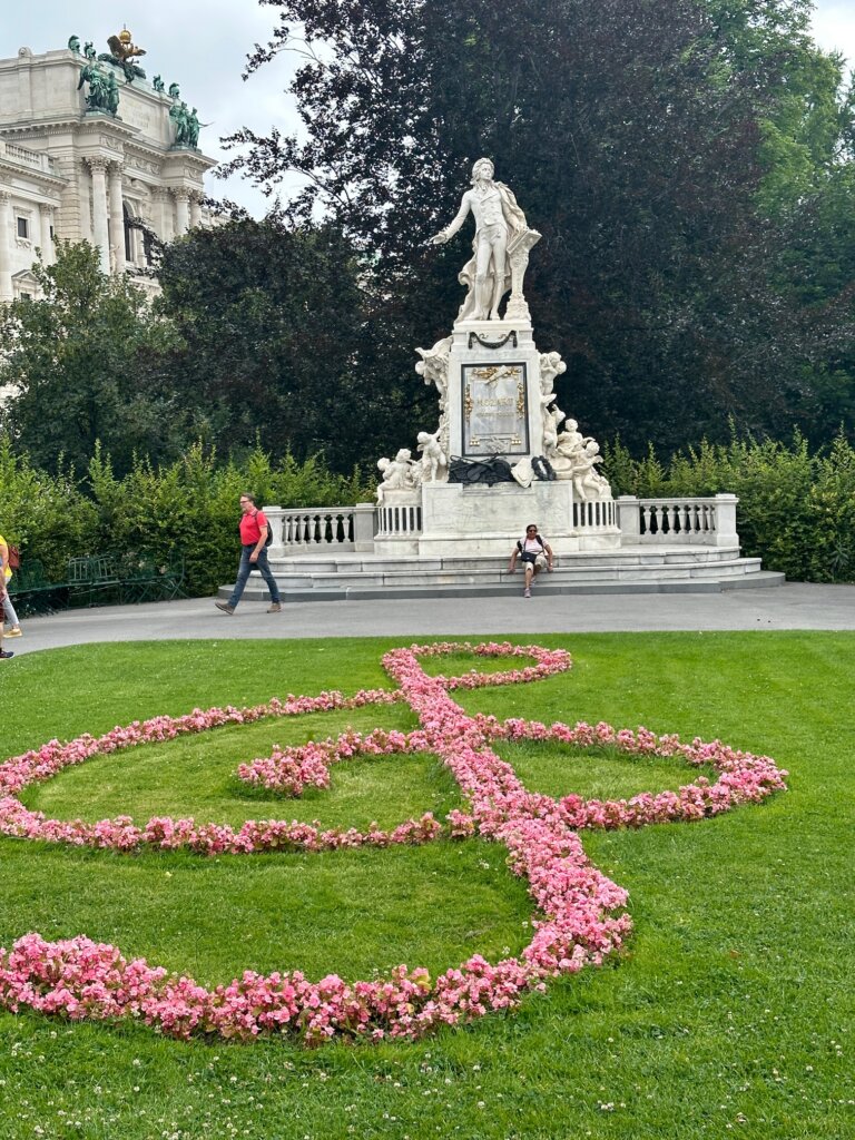 Statue of man with music sign in flowers