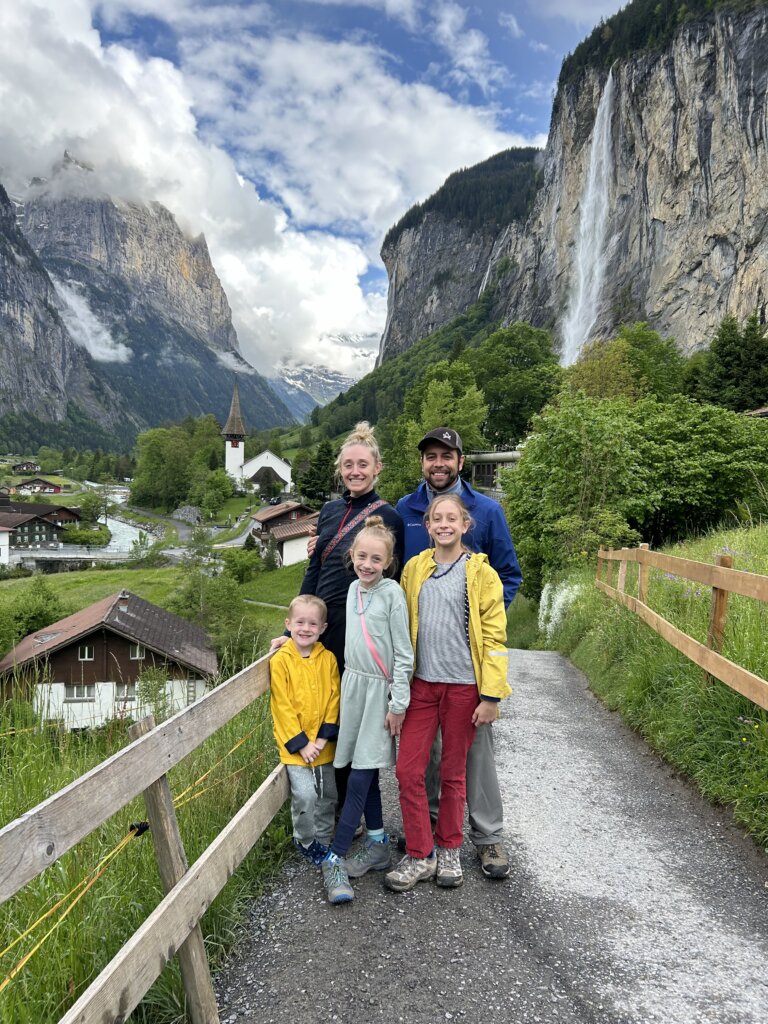 Family on path with large mountains in background