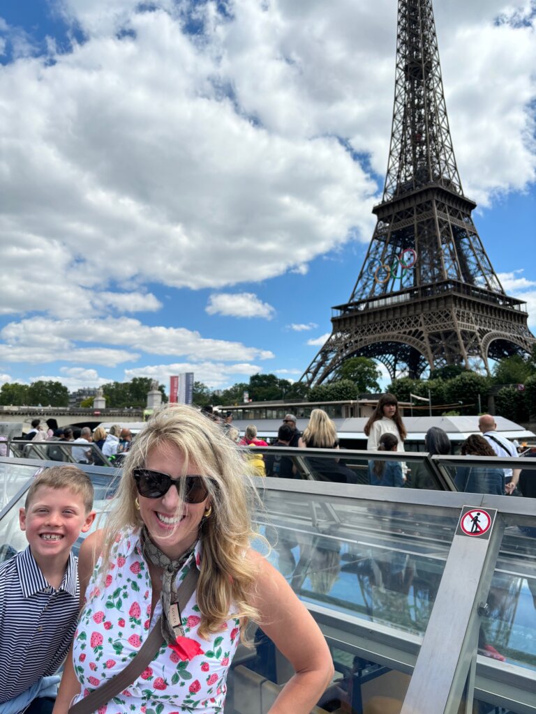 Woman and boy in front of large tower.