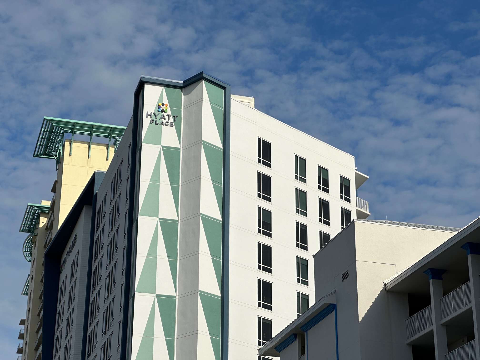 White hotel with turquoise trim that says Hyatt Place